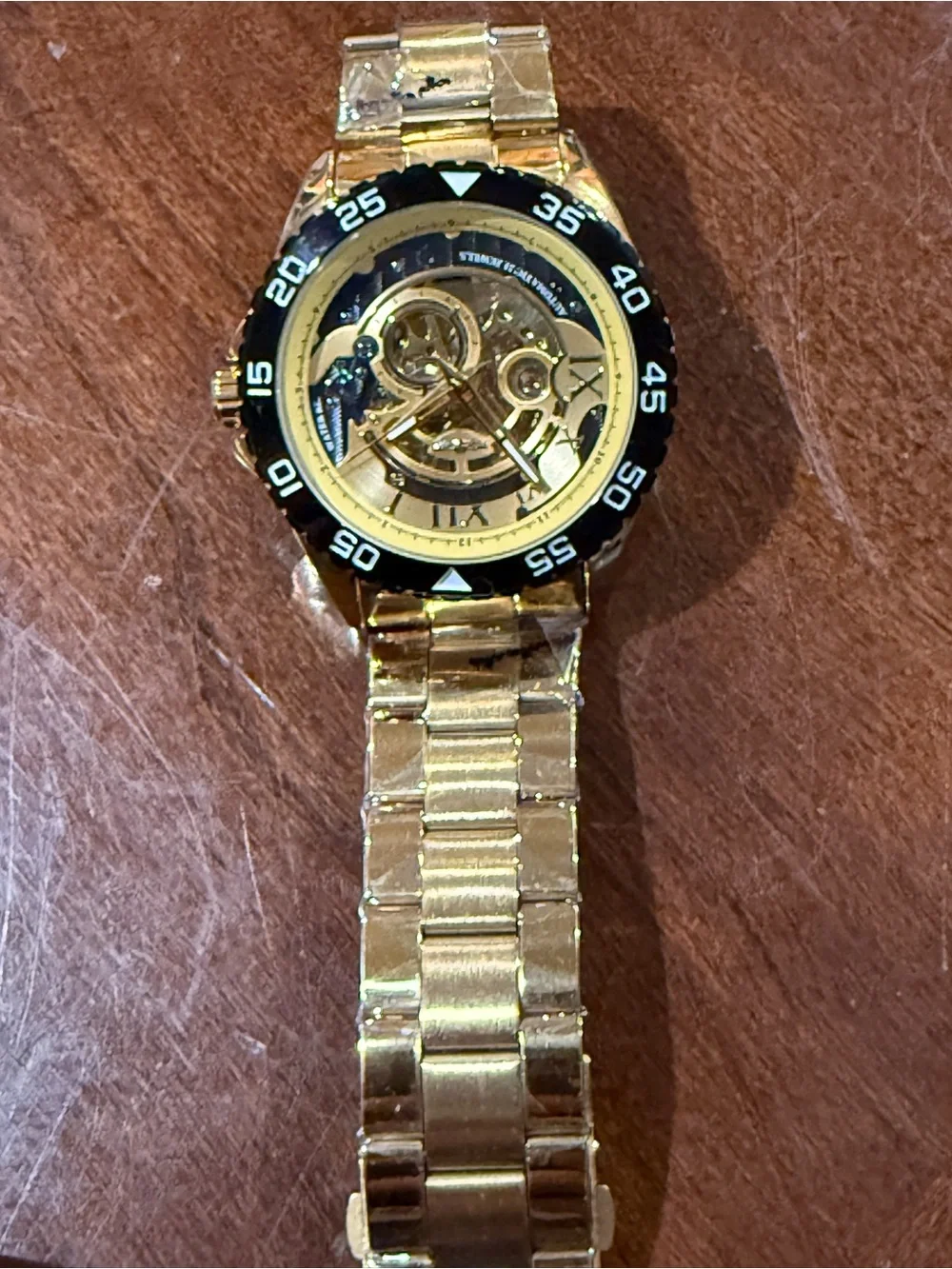Men's Gold Skeleton Automatic Watch with Black Bezel